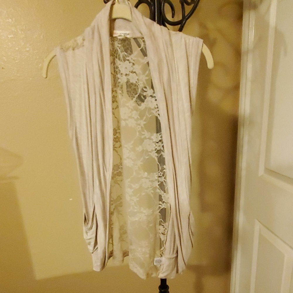 Cream sleeveless cardigan with laced back